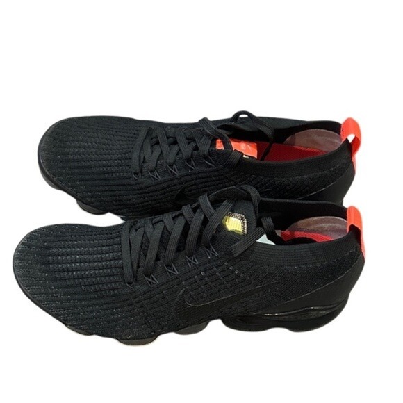 black Nike Air VaporMax Flyknit 3 sneakers with bright crimson/orange accents
